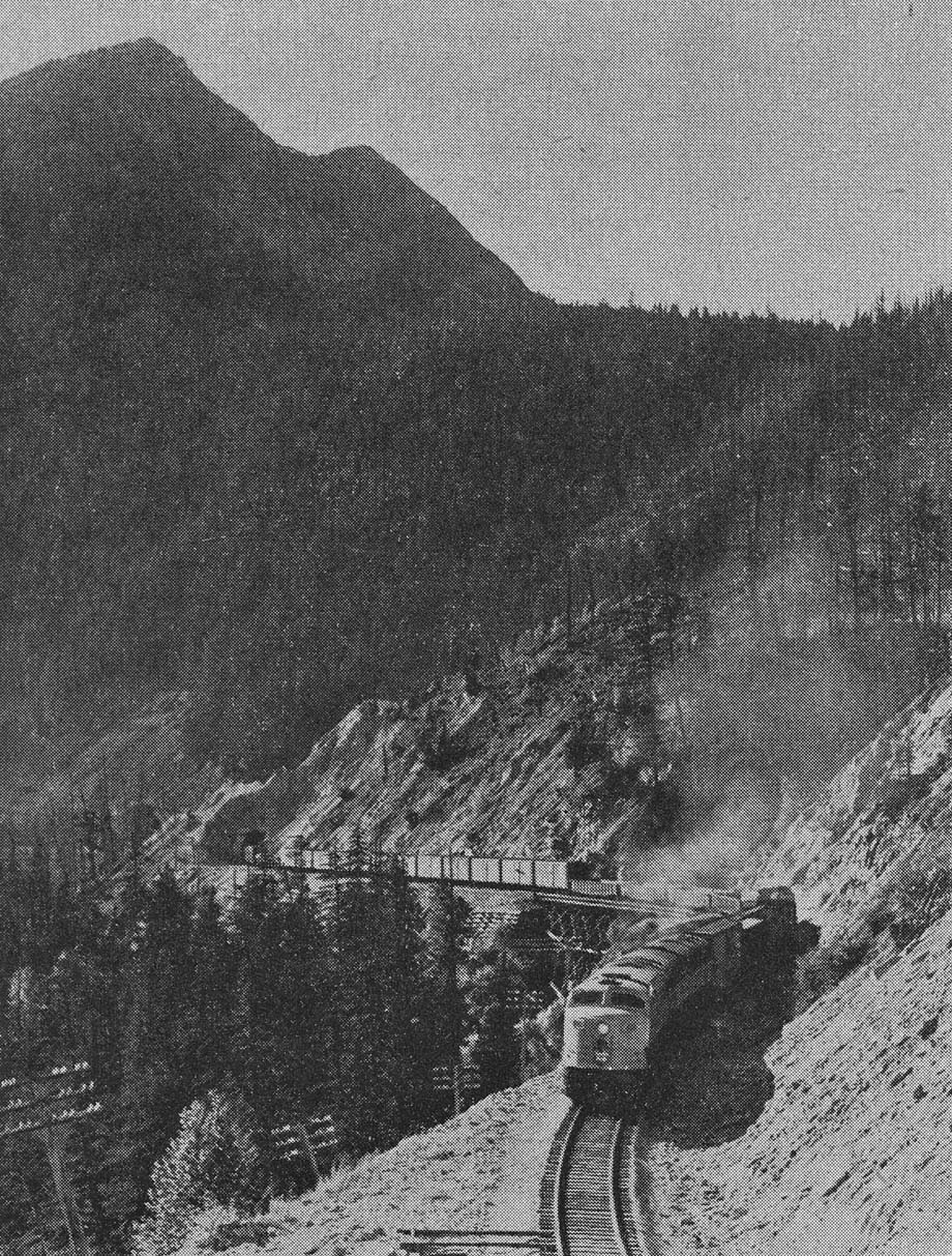 An eastbound freight train winds its way up the pass.