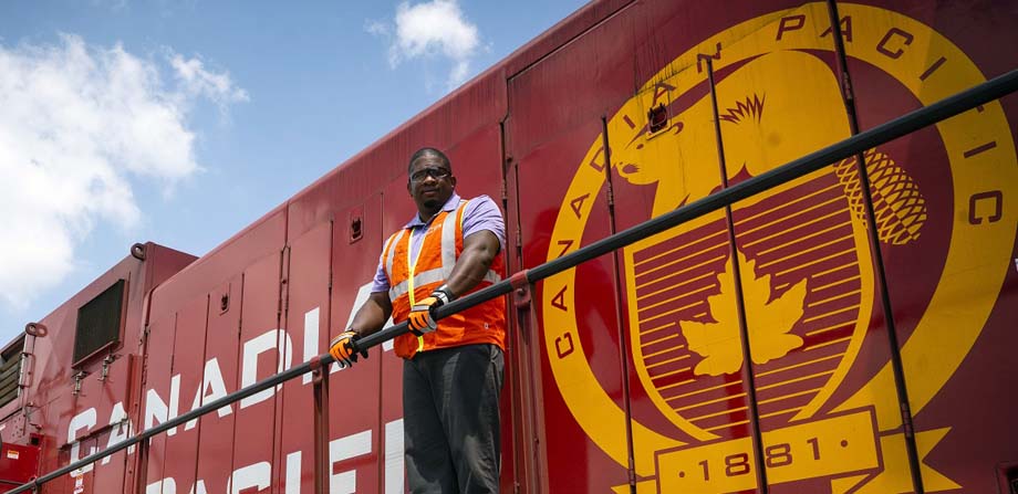 A CP employee on a locomotive wearing the latest logo.
