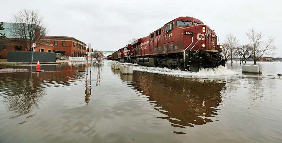 A CP train travels through flooded Davenport.