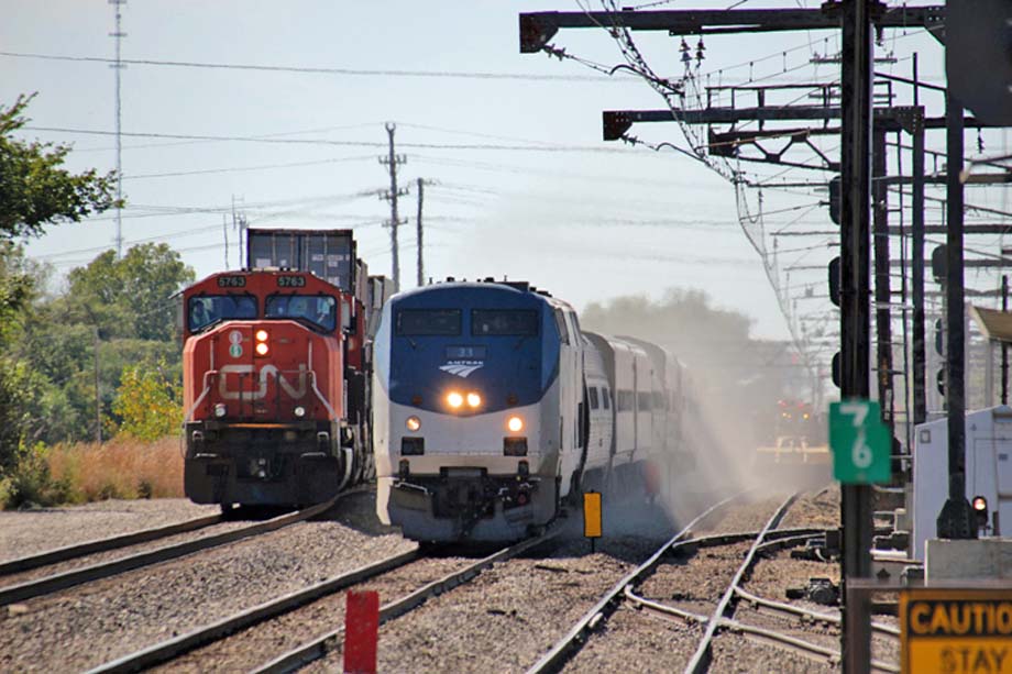 Amtrak's Saluki kicks up dust as it passes a CN train.