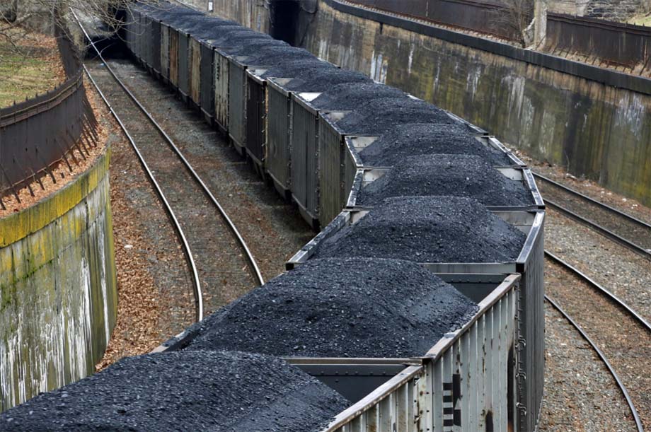 A freight train hauls coal through downtown Pittsburgh.