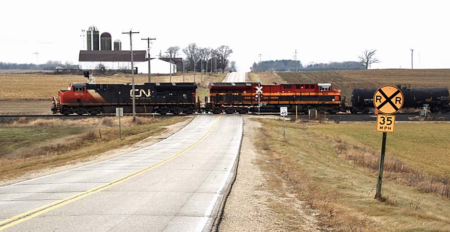 CN and KCS locomotives cross County Road Y near Byron, Wisconsin.