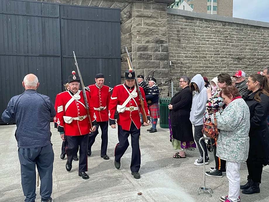 The Brockville Infantry Company march past the Brockville Tunnel doors.