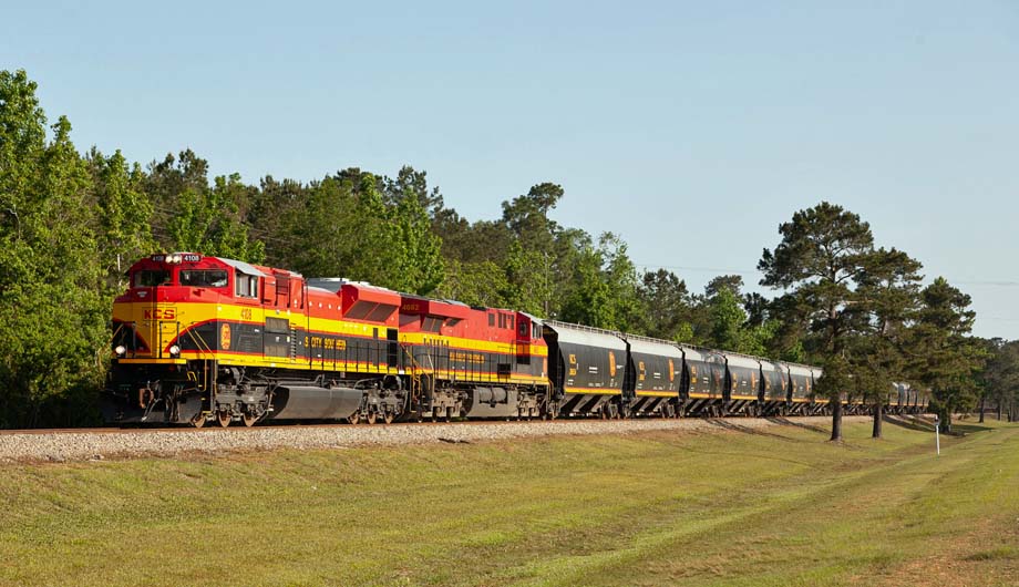 KCS locomotives head a grain train.