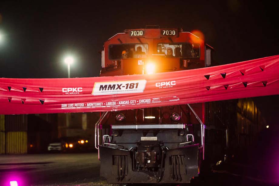 The first CPKC MMX-181 intermodal train approaches the banner.