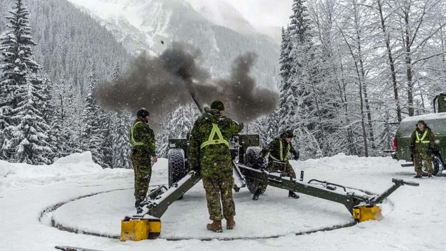 Gunners fire a 105 mm Howitzer in Rogers Pass.